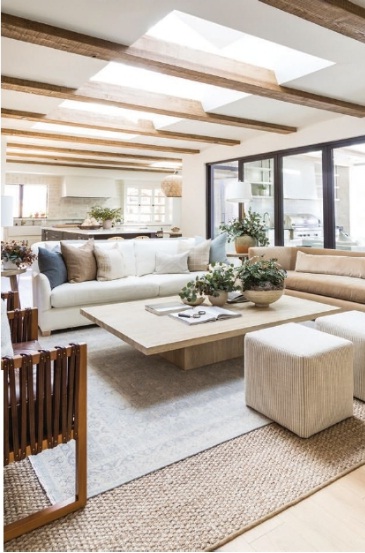 Pure Salt Interiors’ Corbin sofa and Commodore lounge chairs mingle with a Restoration Hardware coffee table in the main house’s great room, where skylights between the ceiling’s exposed beams maximize sunlight. PHOTOGRAPHED BY VANESSA LENTINE