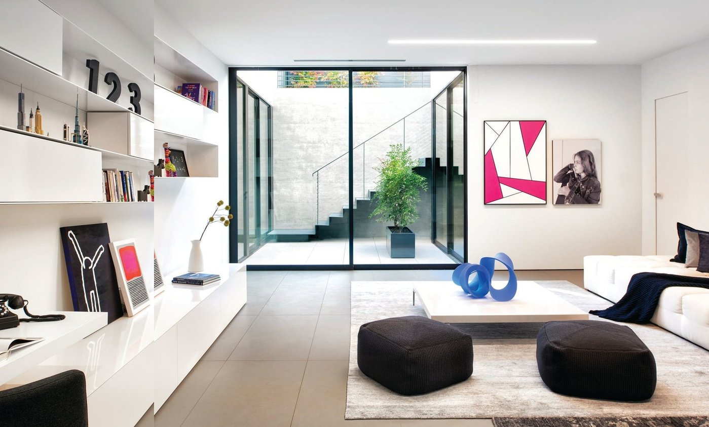 Contemporary art and furnishings are featured in a stunning family room. PHOTO BY JOHN SUTTON