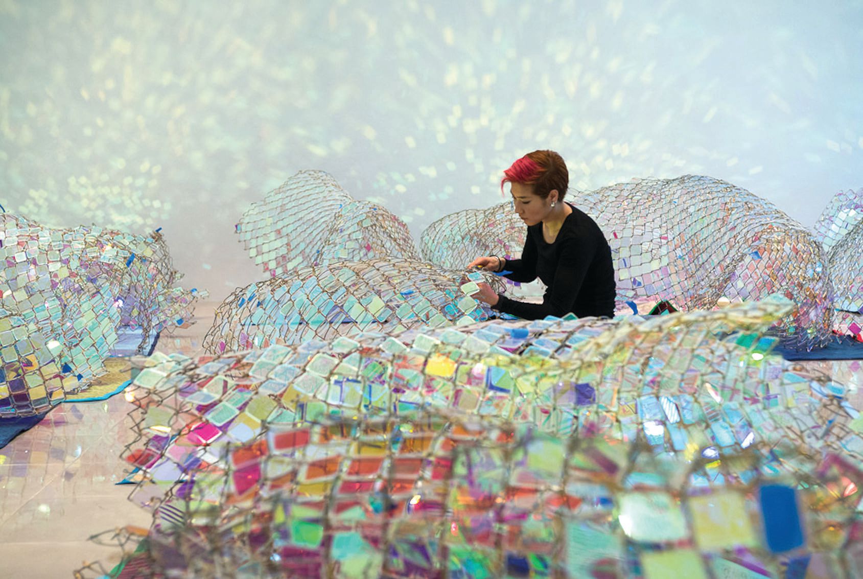 Artist Soo Sunny Park works on the installation of her new exhibit in San Jose. PHOTO BY: NASH BAKER
