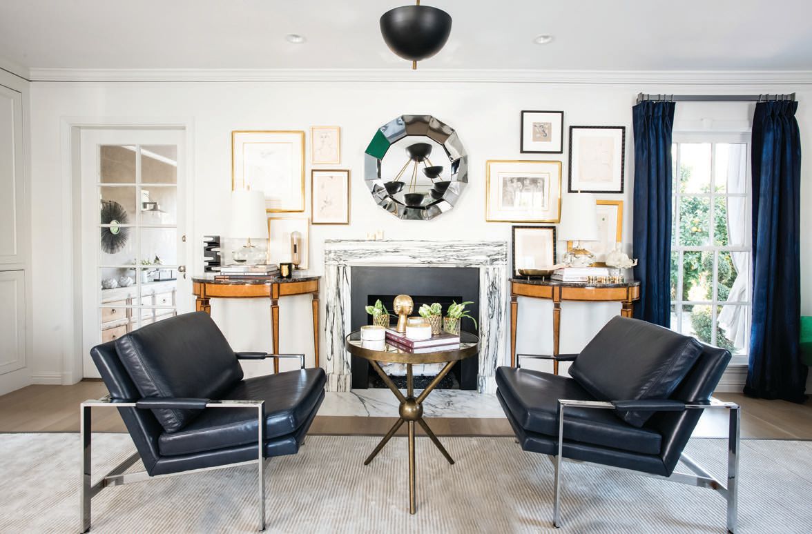 The fireplace seating area features a pair of vintage Milo Baughman chrome lounge chairs in navy blue leather, which sit atop a custom strié taupe wool rug by Stark Carpet PHOTOGRAPHED BY CHRISTOPHER STARK