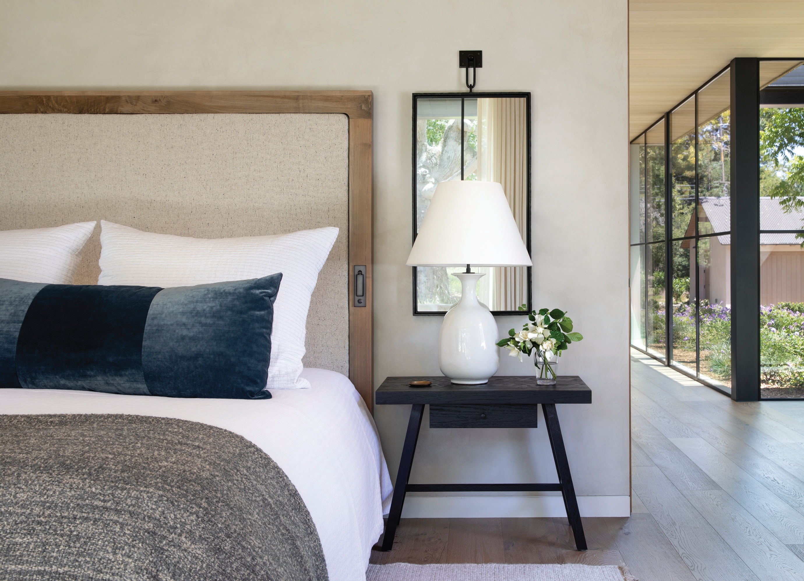 Much like the rest of the home, the owner’s suite connects to the outdoors with natural tones—a bed from Jeff Martin Joinery completes the look.  PHOTOGRAPHED BY PAUL DYER