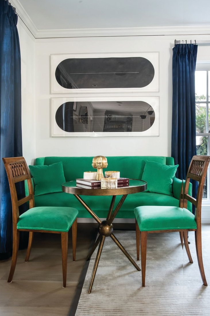 Black ink original drawings by Sam Still sit atop a vignette of neoclassical musical chairs and settee, upholstered in Manuel Canovas emerald green cotton velvet. PHOTOGRAPHED BY CHRISTOPHER STARK